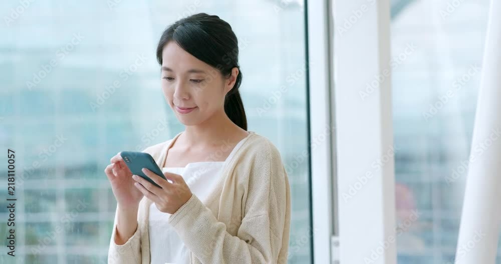 Woman use of mobile phone in the airport Woman use of mobile phone in the airport