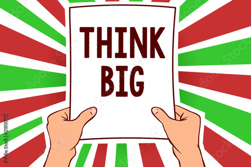 Writing note showing Think Big. Business photo showcasing To plan for something high value for ones self or for preparation Man holding paper important message remarkable red rays bright ideas. photo