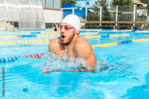 Photography Man swims breaststroke in the pool