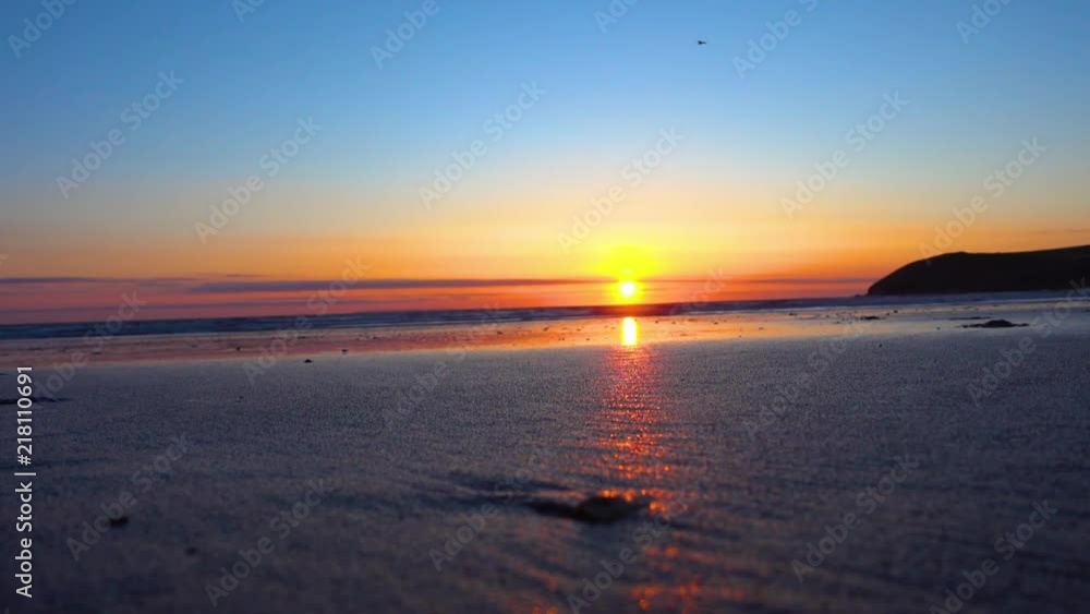 Running on a sandy beach at sunset in Devon Running on a sandy beach at sunset in Devon