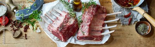Panorama banner with two uncooked racks of lamb photo