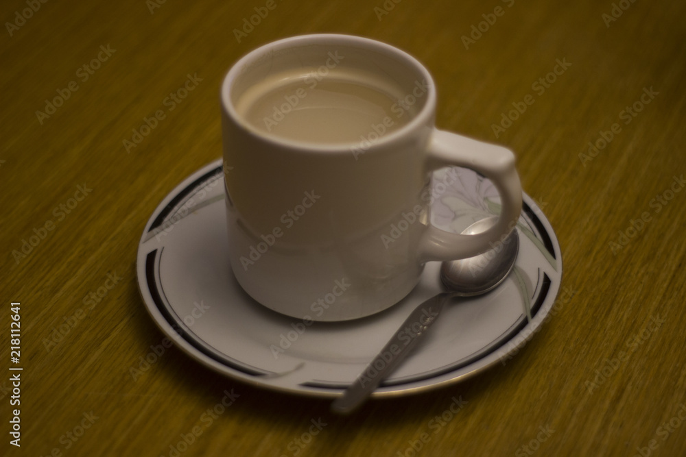 Latte coffee cup in a plate with a spoon Latte coffee cup in a plate with a spoon