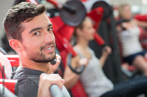 joyful positive man working out in a gym