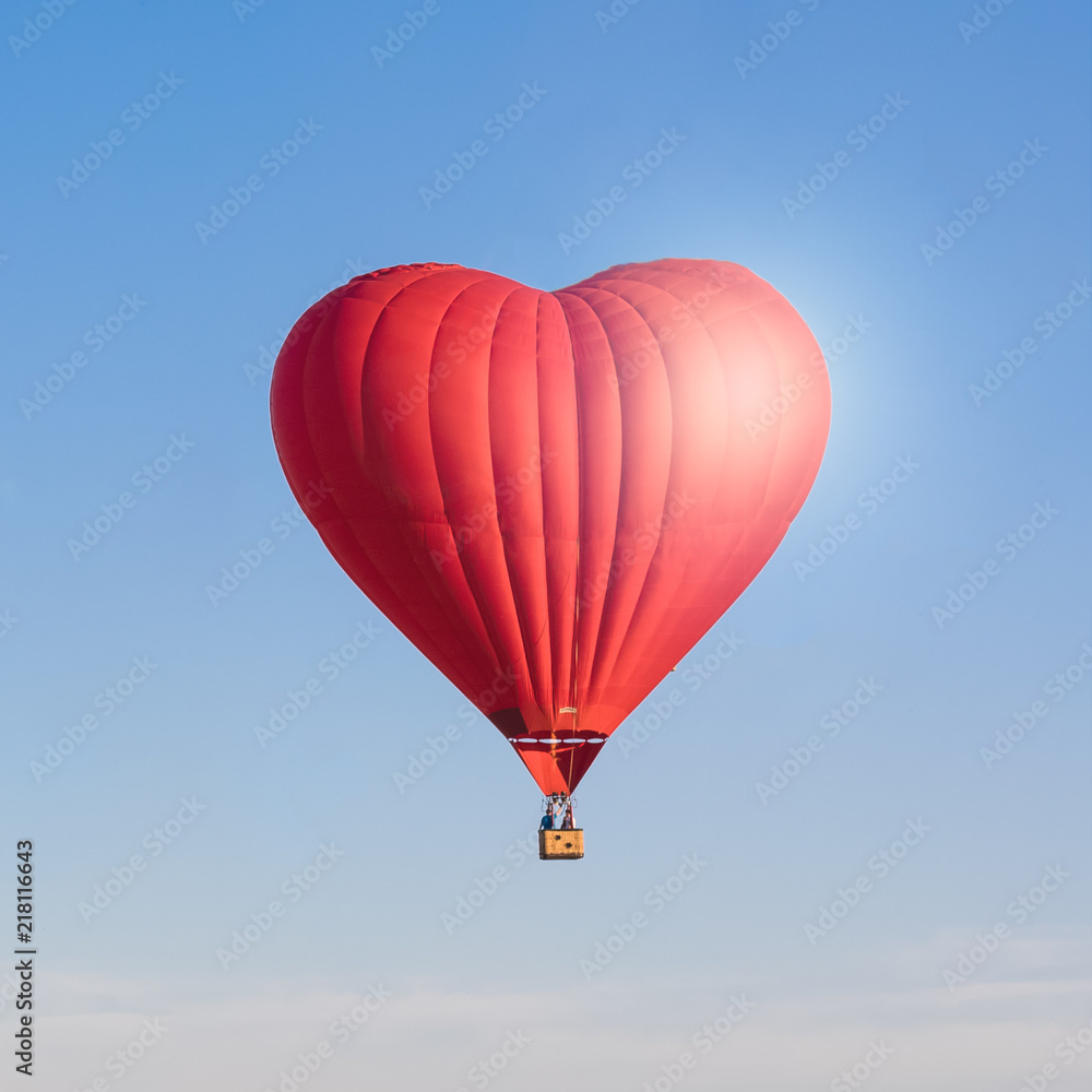 Red heart shaped air ballon isolated in the sky Red heart shaped air ballon isolated in the sky