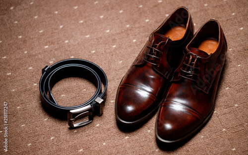 classic brown shoes and belt on wooden floor. vintage picture