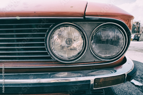 Headlight of a red vintage classic car. © Alessandro Vecchi