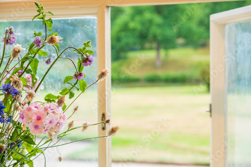 Flowers and window view at Lyme Hall in Peak District, Cheshire, UK photo