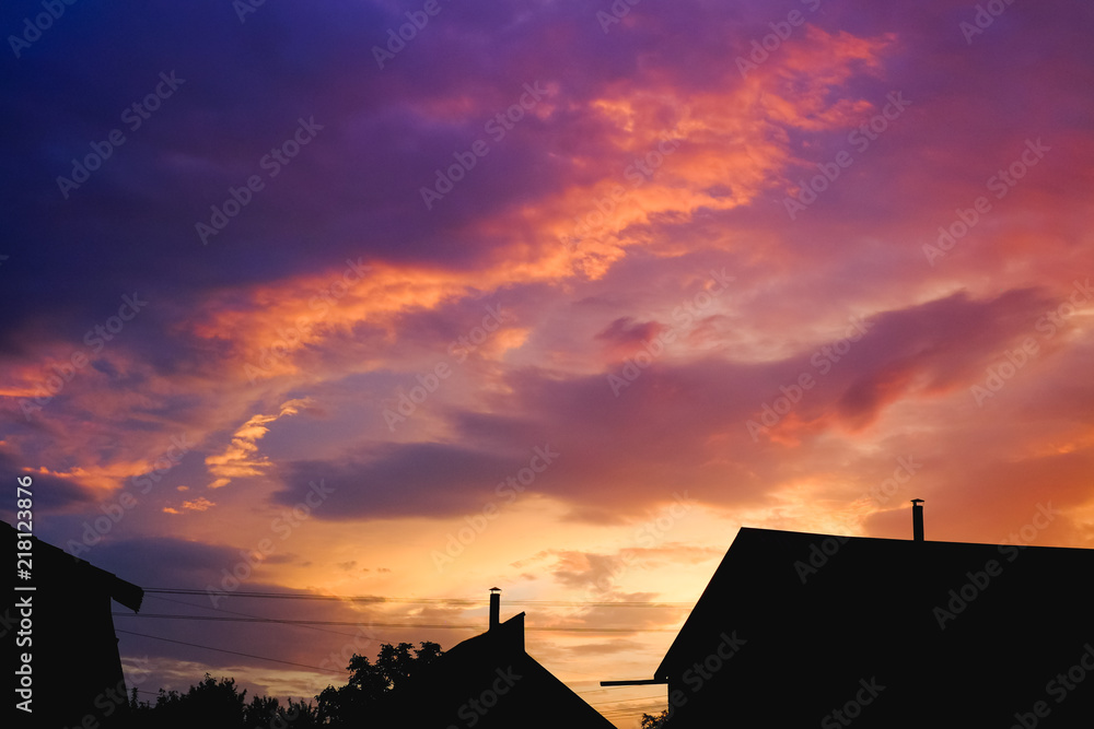 Silhouette of a house and the tree in the purple sunset