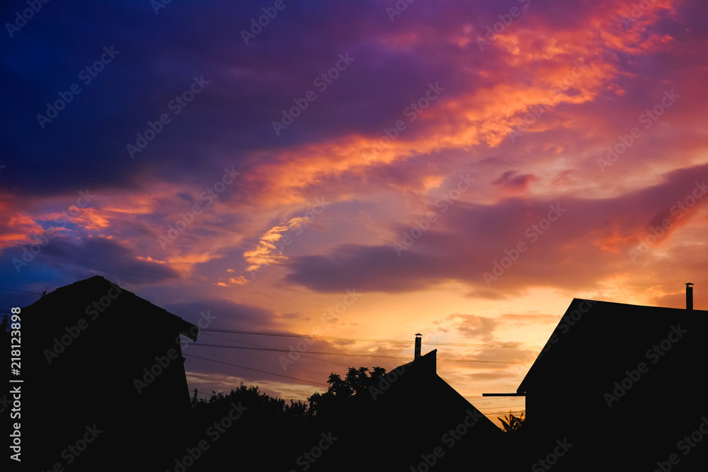 Silhouette of a house and the tree in the purple sunset