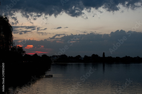 Altocumulus clouds at sunset over the lake photo