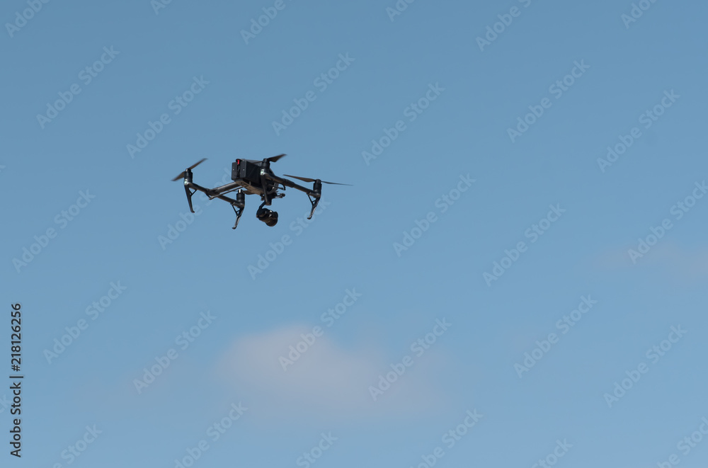 The drone in the blue sky. Close up of quadrocopter outdoors. The drone in the blue sky. Close up of quadrocopter outdoors.