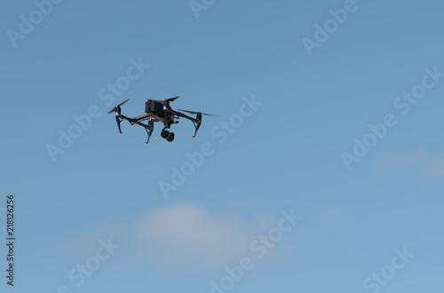 The drone in the blue sky. Close up of quadrocopter outdoors.