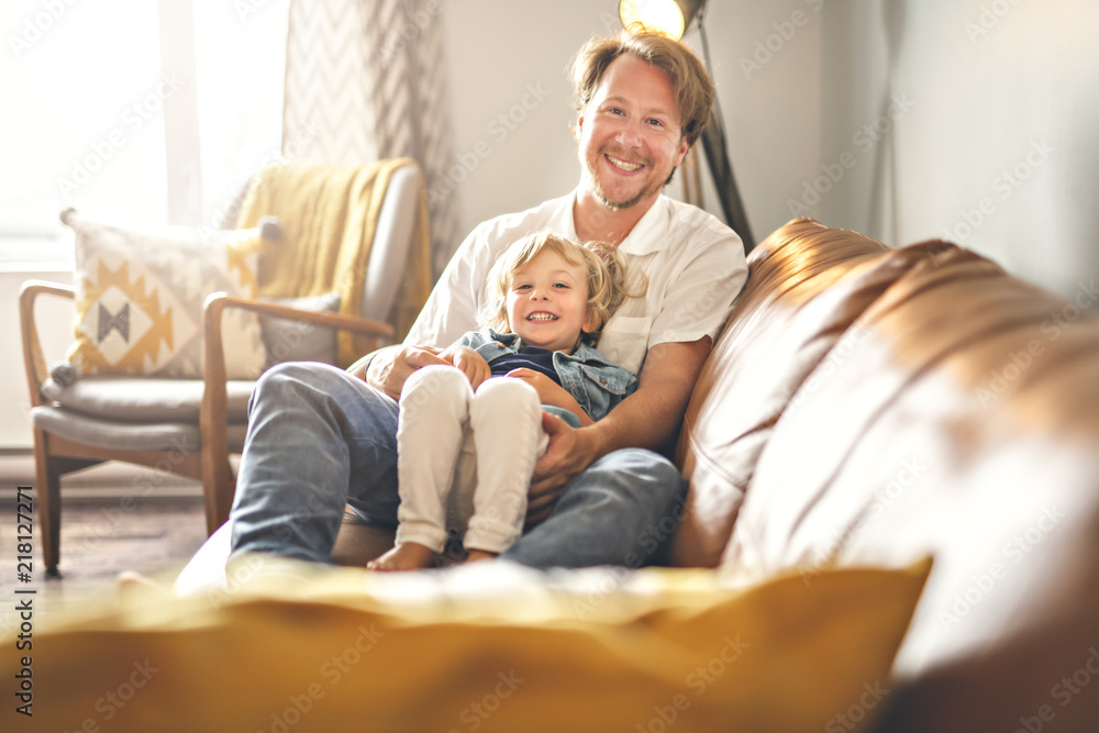 Portrait of happy son with father at home