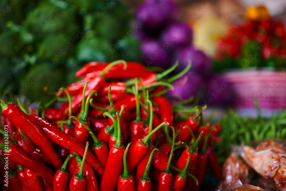 Bright summer background. Red chili in farmer market. Healthy vegetarian vegetables, organic food, raw ingredient. Natural nutrition for diet. Organic vegetables. Summer crops. Selective focus. Bright summer background. Red chili in farmer market. Healthy vegetarian vegetables, organic food, raw ingredient. Natural nutrition for diet. Organic vegetables. Summer crops. Selective focus.