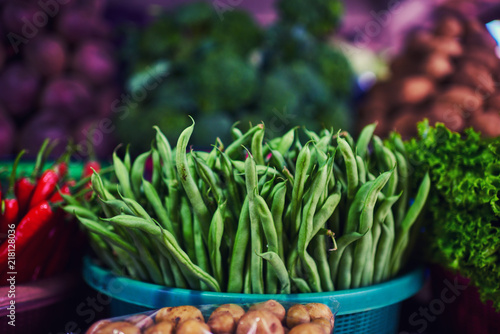 Bright summer background. Green beans in farmer market. Healthy vegetable vegetarian  organic food  raw ingredient. Natural nutrition for diet. Organic vegetables. Summer crops. Selective focus.