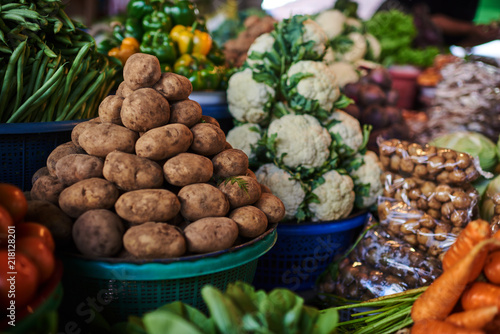 Assortment fresh organic vegetables. Country style market. Concept local farmer produce. Fruits and vegetables at a farmers market. Eco food. Baskets full of locally grown vegetables at local market.