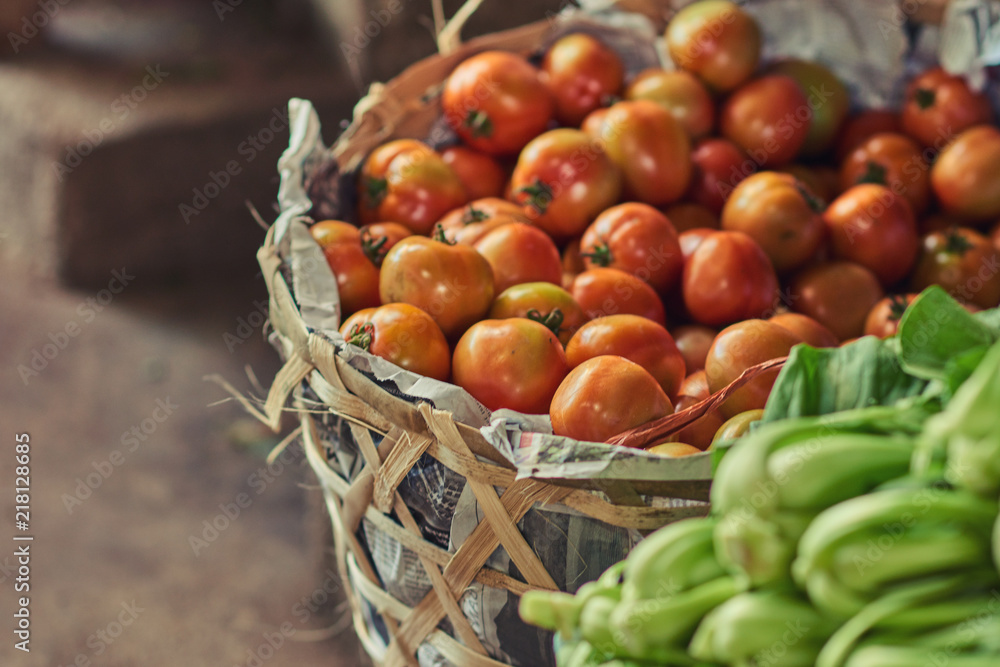 Fresh tomatoes from farm in a basket. Fresh organic produce on sale at the local farmers market. Selective focus. Fresh tomatoes from farm in a basket. Fresh organic produce on sale at the local farmers market. Selective focus.