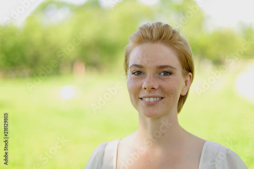Woman relaxing and enjoying the sun in a warmth park at sunset