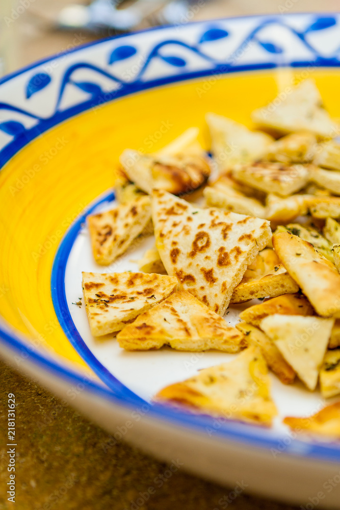 Closeup of Sliced Savoury Flatbread on a Decorative Plate Closeup of Sliced Savoury Flatbread on a Decorative Plate