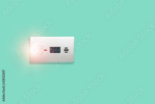 Quadro su tela Carbon monoxide sensor isolated on a green pastel background, alarming high concentration of carbon monoxide