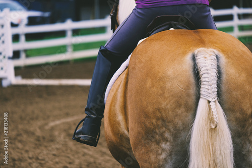 Person riding English on Haflinger horse in county fair show arena.