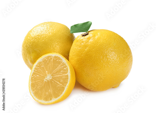 Ripe whole and sliced lemons on white background