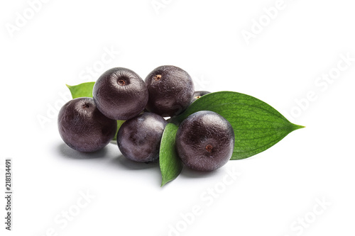 Fresh acai berries with leaves on white background