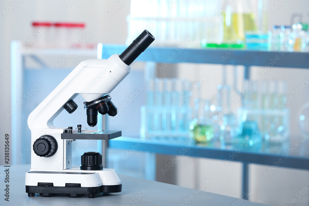 Modern microscope on table in laboratory. Chemical analysis Modern microscope on table in laboratory. Chemical analysis