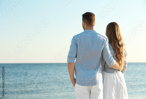 Happy young couple resting together on beach