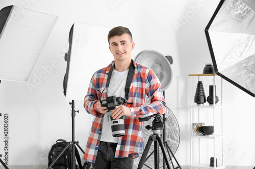 Young male photographer wor...