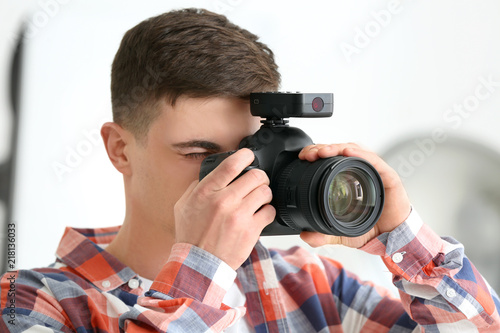 Young male photographer wor...