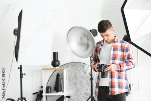 Young male photographer wor...
