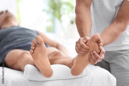 Bilde på lerret Young man receiving massage in salon, closeup