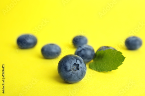 Tasty ripe blueberry on color background  closeup