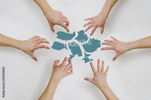 Wallpaper Mural Division of the State of Ukraine. The drawn hands reach for pieces of Ukraine. Conflict in Ukraine with Russia, the concept of politics. Problems of Ukraine and Ukrainians. Torontodigital.ca