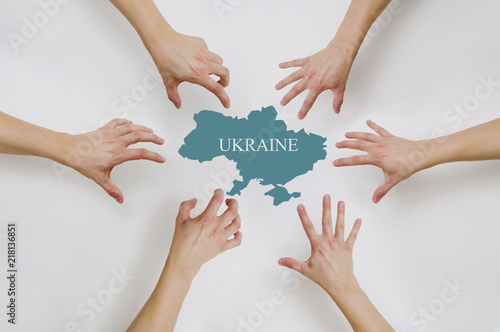 Division of the State of Ukraine. The drawn hands reach for pieces of Ukraine. Conflict in Ukraine with Russia, the concept of politics. Problems of Ukraine and Ukrainians.