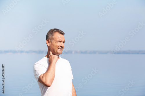 Man checking pulse outdoors on sunny day