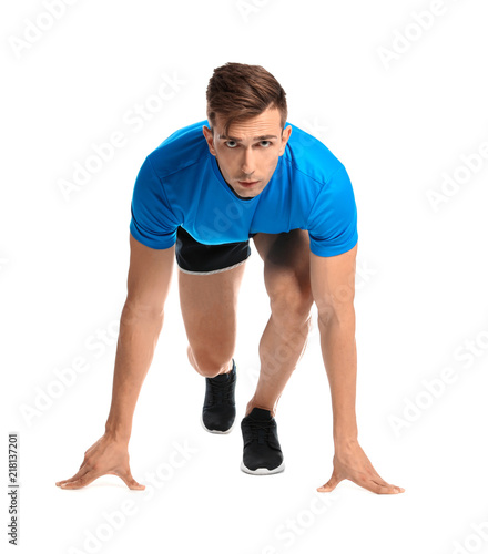 Sporty young man running on white background