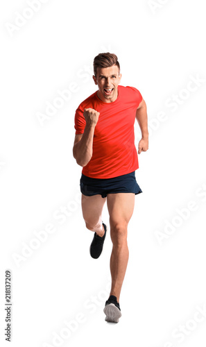 Sporty young man running on white background