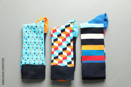Flat lay composition with different colorful socks on gray background