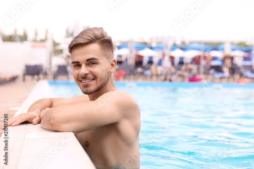 Young man in pool on sunny day © New Africa
