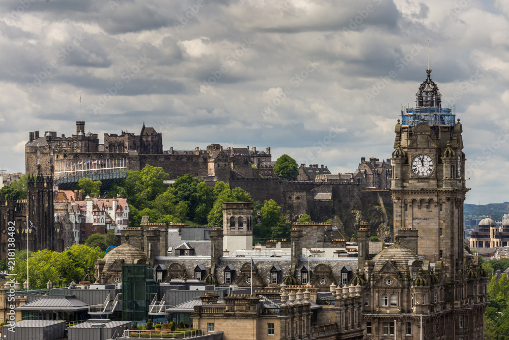 Edinburgh, Scotland, UK - June 13, 2012: Looking from Calton Hill upon the Balmoral Clock Tower along Princess street and the Castle under Heavy Cloudscape.