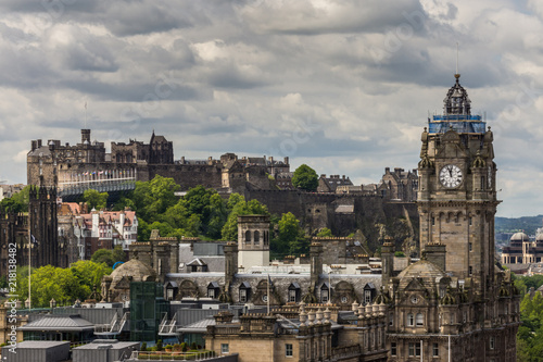 Edinburgh, Scotland, UK - June 13, 2012: Looking from Calton Hill upon the Balmoral Clock Tower along Princess street and the Castle under Heavy Cloudscape.