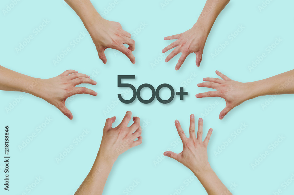 Top view of hands reaching for the social program in Poland 500+. People are throwing themselves in 500+ funding for families with children. Concept of country help, country problems.