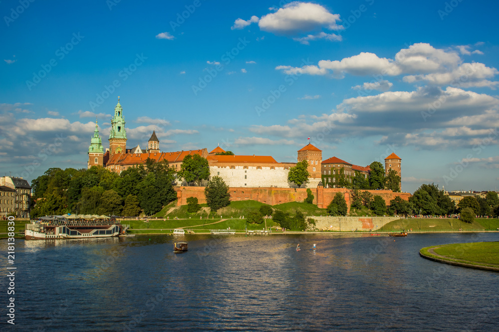 beautiful medieval european castle near river waterfront old city district and space for walking concept shot in bright colorful contrast summer day time without people on blue sky background 