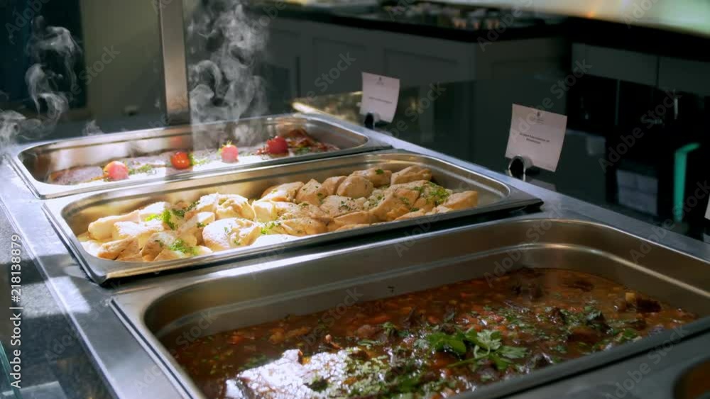 buffet: people take food in plates. buffet: people take food in plates.