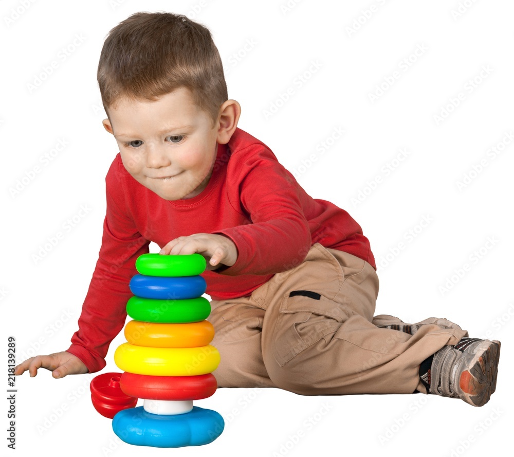 Friendly Little Boy Sitting on Ground and Playing with Toys - Friendly Little Boy Sitting on Ground and Playing with Toys -