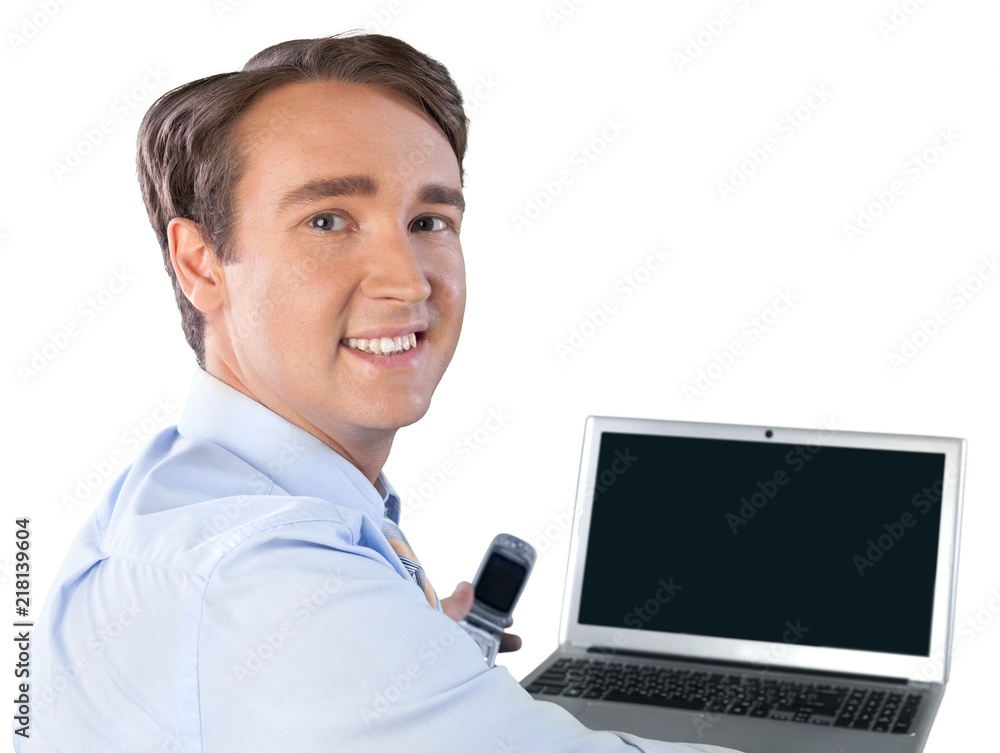 Portrait of young handsome businessman using laptop and phone