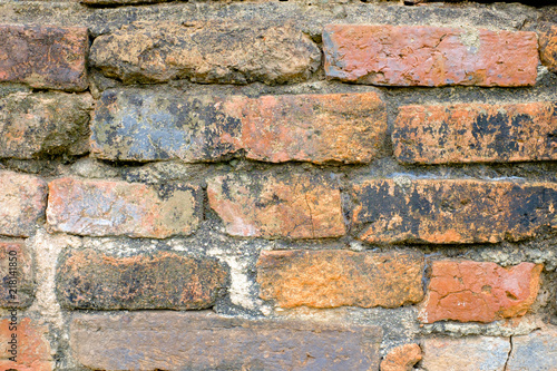 Cracked Dark Orange Old Brick Wall Texture background at thai ancient temple.