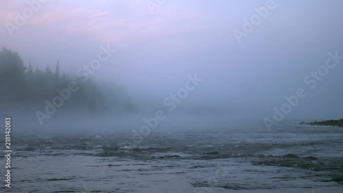 Mist over Lainio river at midnight in July, near Kiruna in Swedish Lapland. photo